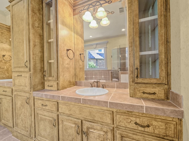 bathroom with walk in shower, crown molding, and vanity