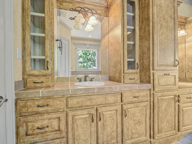 bathroom with vanity and ornamental molding