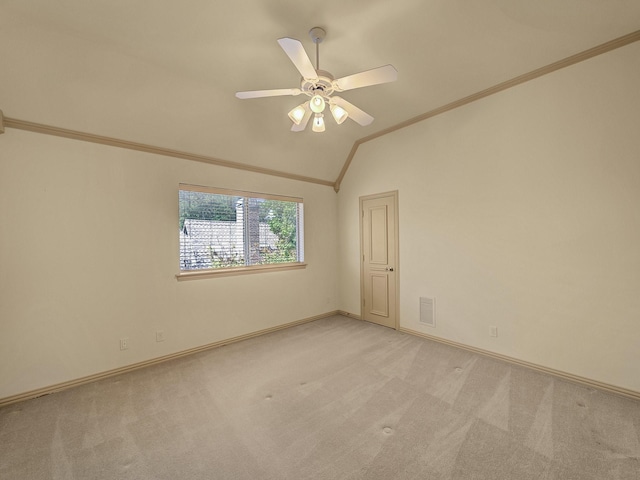 unfurnished room with lofted ceiling, light colored carpet, ceiling fan, and ornamental molding