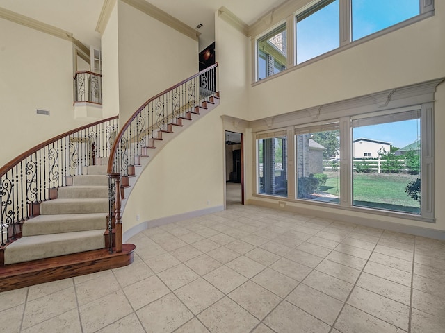 interior space featuring a high ceiling and crown molding