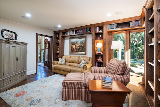 living room featuring crown molding, built in features, and dark hardwood / wood-style flooring