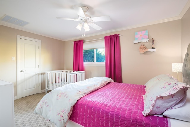 bedroom featuring ceiling fan, ornamental molding, and light colored carpet