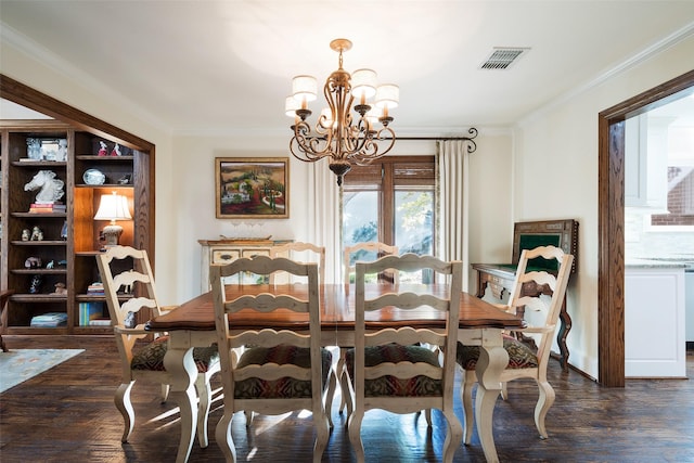 dining room with crown molding, dark hardwood / wood-style floors, and an inviting chandelier