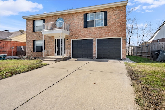 view of front facade with a front lawn, a balcony, and a garage