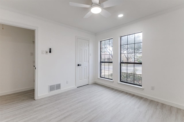 spare room featuring ornamental molding, ceiling fan, and light wood-type flooring