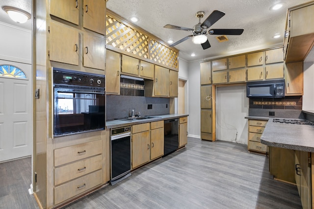 kitchen with decorative backsplash, sink, a textured ceiling, and black appliances