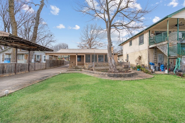 rear view of property featuring ceiling fan and a lawn