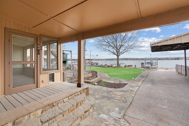 view of patio / terrace featuring a water view and a dock