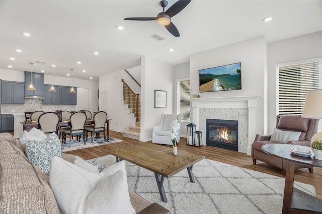 living room featuring light wood-type flooring and ceiling fan