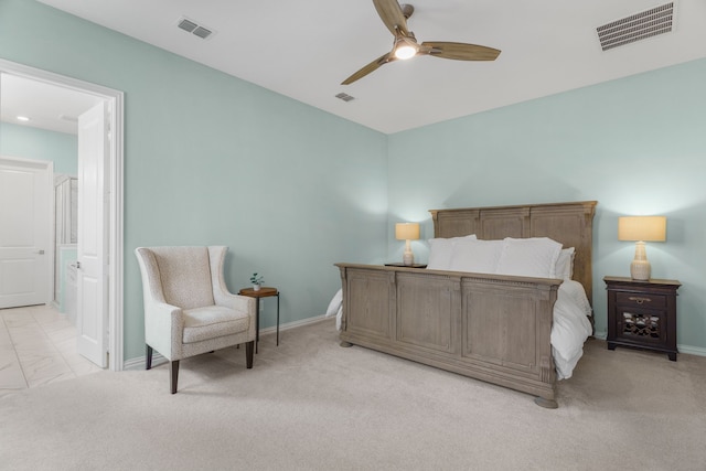 bedroom with ensuite bath, ceiling fan, and light carpet