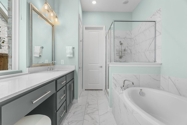 bathroom featuring vanity and separate shower and tub