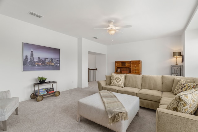 carpeted living room with ceiling fan