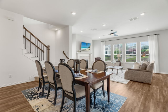 dining area with ceiling fan and wood-type flooring