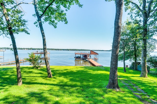 view of dock featuring a water view and a lawn