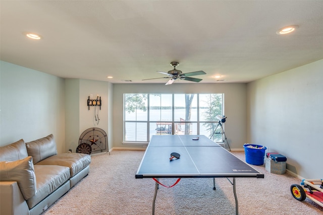 recreation room with ceiling fan and light colored carpet