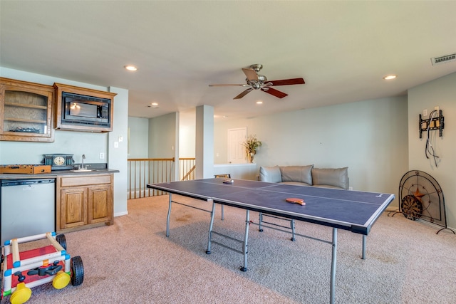 playroom featuring ceiling fan, light colored carpet, and wet bar