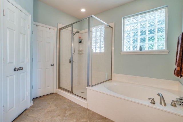 bathroom featuring independent shower and bath and tile patterned flooring