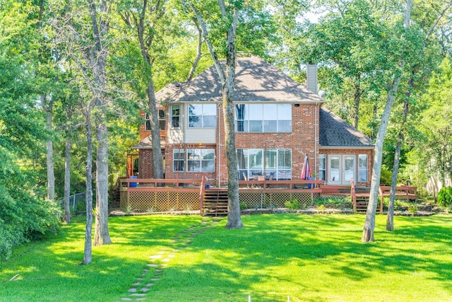 back of house with a lawn and a deck