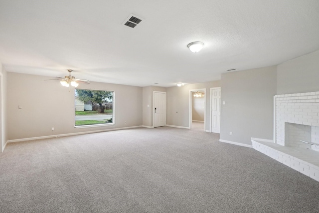 unfurnished living room with a fireplace, a textured ceiling, carpet, and ceiling fan