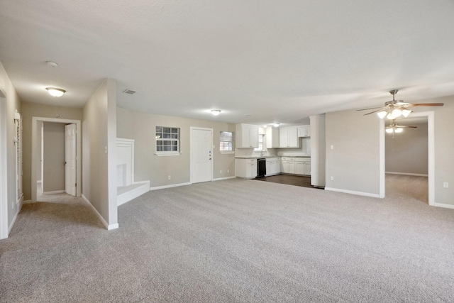 unfurnished living room with ceiling fan and light carpet