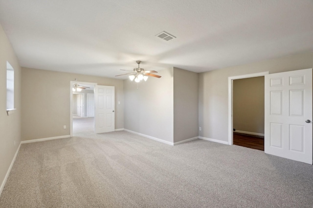 carpeted empty room with ceiling fan