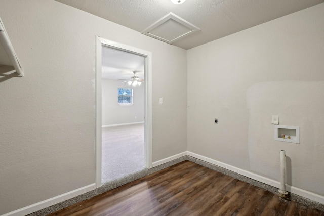 laundry room with hookup for a washing machine, a textured ceiling, dark hardwood / wood-style flooring, and electric dryer hookup