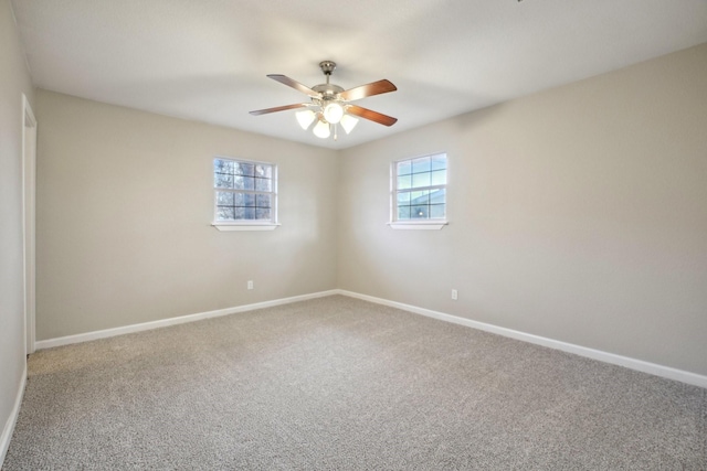 carpeted spare room with ceiling fan