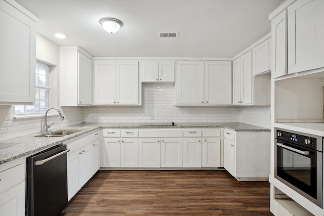 kitchen with sink, backsplash, white cabinets, and stainless steel appliances