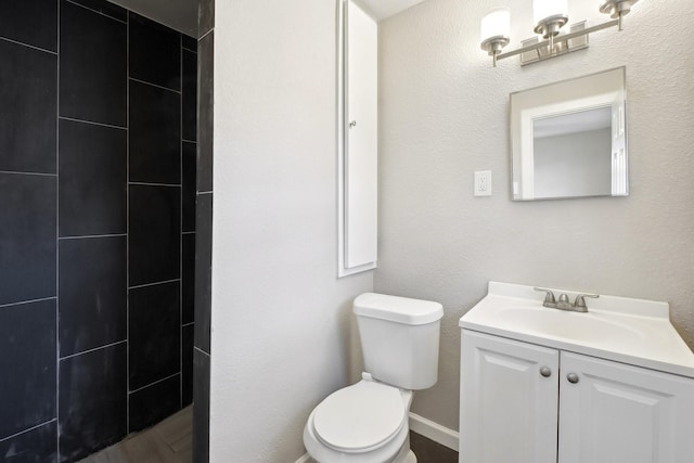 bathroom with a shower, toilet, and vanity