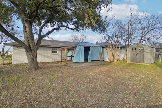 back of house featuring a yard and a storage shed