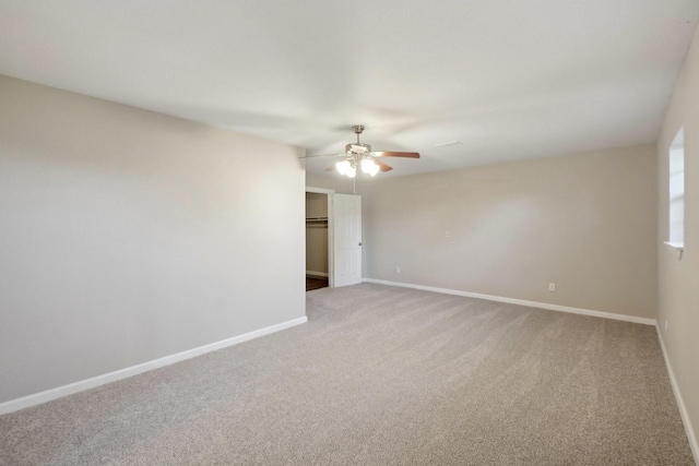 spare room featuring carpet floors and ceiling fan