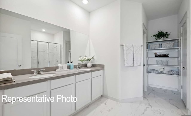 bathroom featuring vanity and an enclosed shower