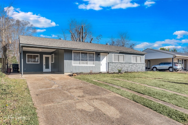 single story home featuring a front lawn and a carport