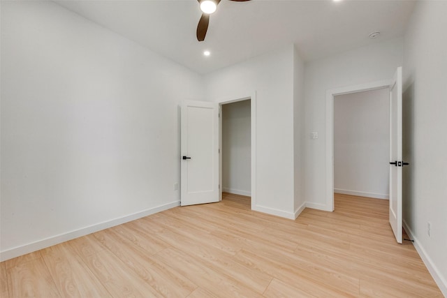 unfurnished bedroom featuring ceiling fan, a closet, and light hardwood / wood-style floors