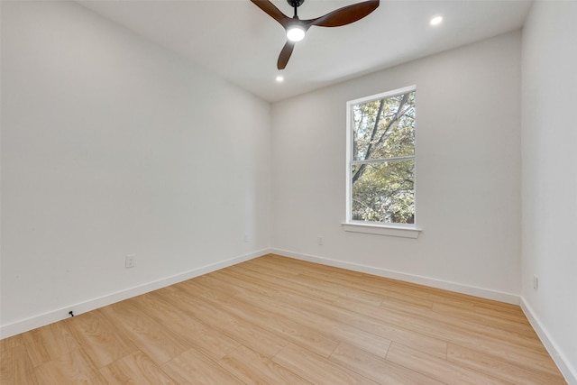 empty room with ceiling fan and light hardwood / wood-style flooring