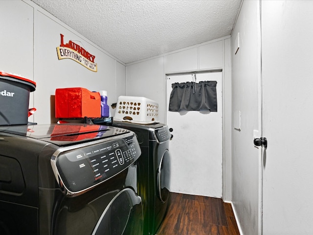 clothes washing area with a textured ceiling, dark hardwood / wood-style floors, and separate washer and dryer