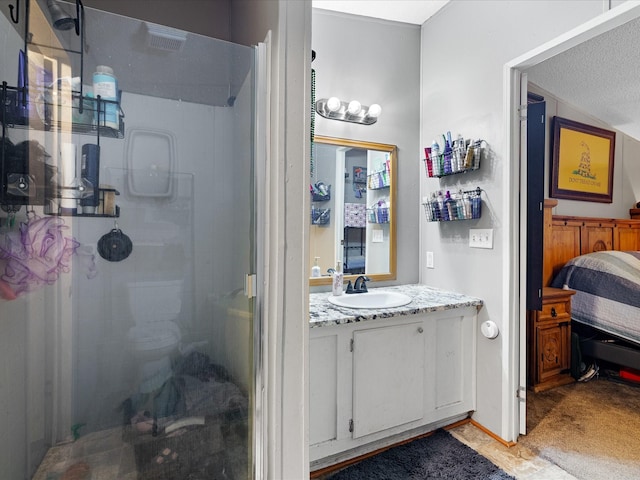 bathroom featuring walk in shower and vanity