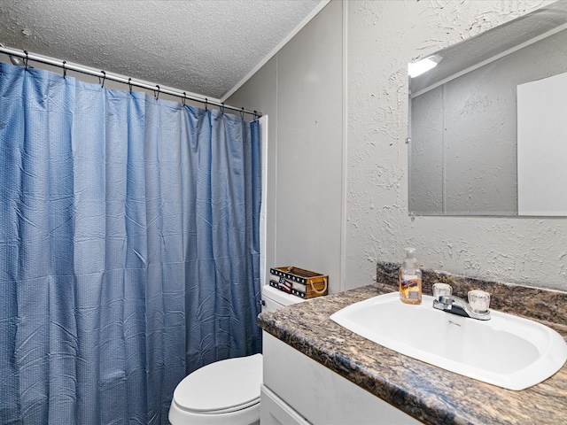 bathroom featuring a textured ceiling, toilet, vanity, and ornamental molding