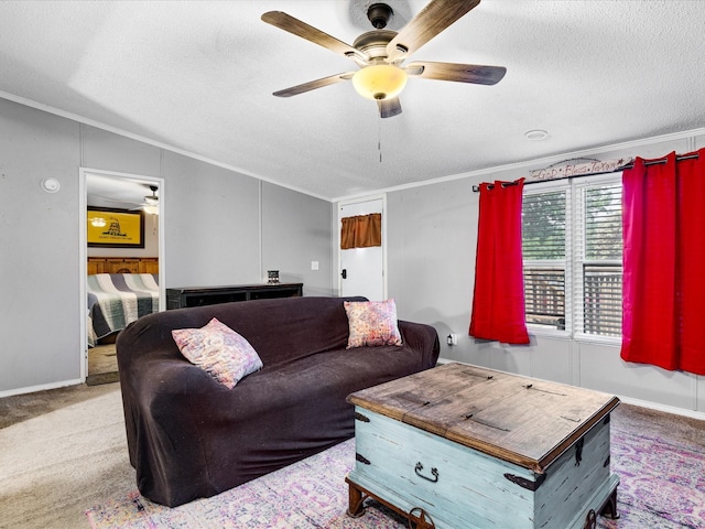 carpeted living room featuring ceiling fan, a textured ceiling, lofted ceiling, and ornamental molding