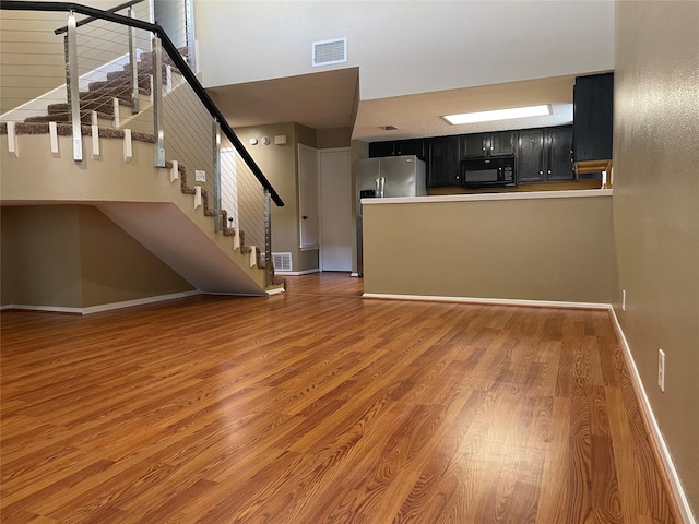 unfurnished living room with dark hardwood / wood-style floors