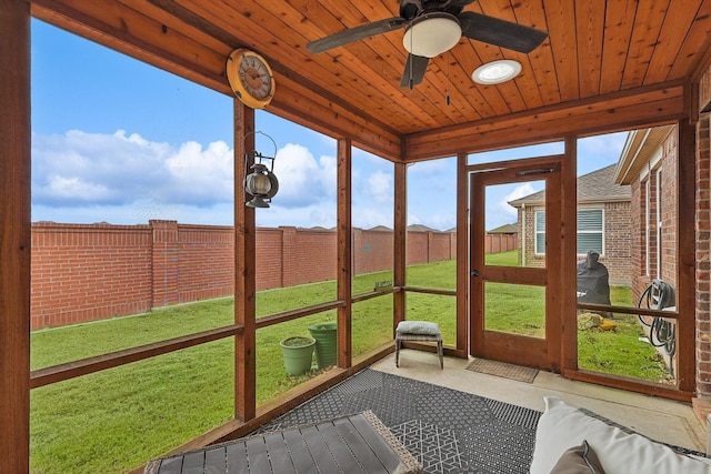 unfurnished sunroom with ceiling fan and wooden ceiling