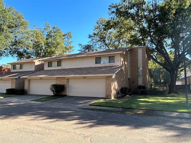 view of front facade with a front lawn and a garage