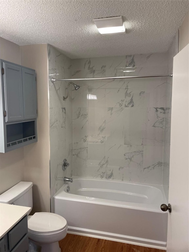 full bathroom with tiled shower / bath, a textured ceiling, and hardwood / wood-style floors