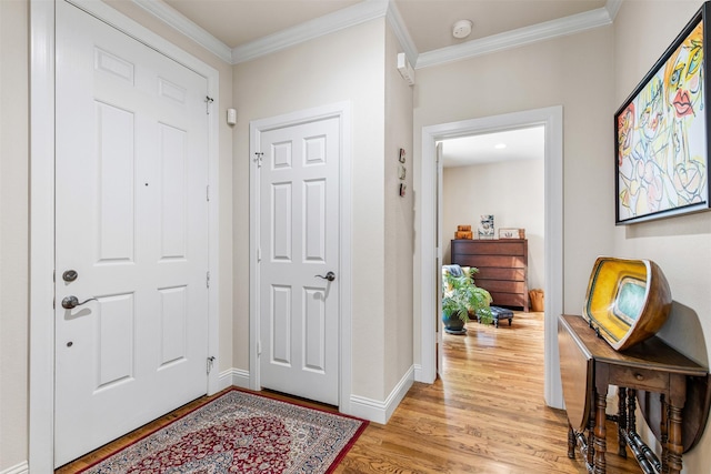 entrance foyer featuring crown molding and light hardwood / wood-style floors