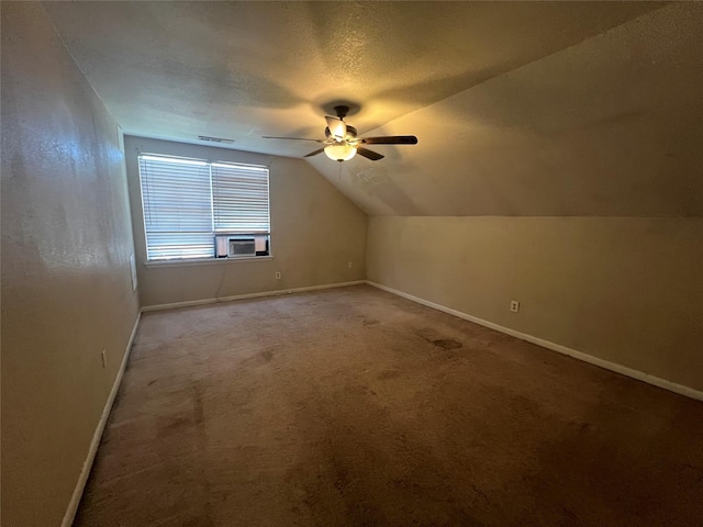 bonus room featuring ceiling fan, a textured ceiling, carpet, and lofted ceiling