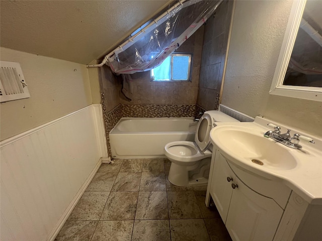 bathroom with toilet, a textured ceiling, a washtub, and vanity