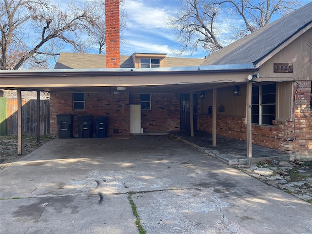 rear view of property featuring a carport