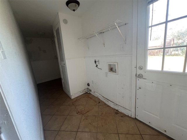 clothes washing area featuring light tile patterned floors and hookup for a washing machine