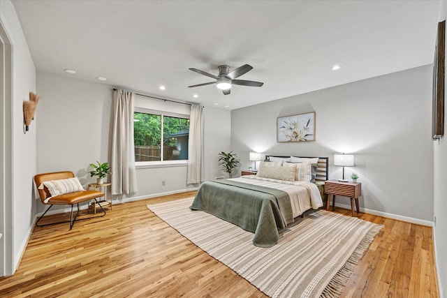 bedroom with ceiling fan and light hardwood / wood-style floors