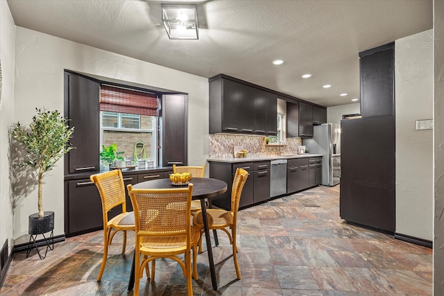 dining area featuring sink and a textured ceiling